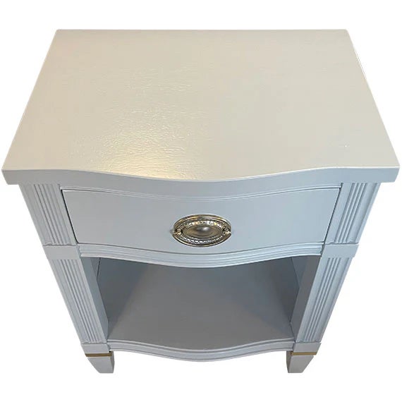 Chic and refined, this one-drawer nightstand pairs tailored lines with subtle glamour. Finished in a soft gray lacquer and...
