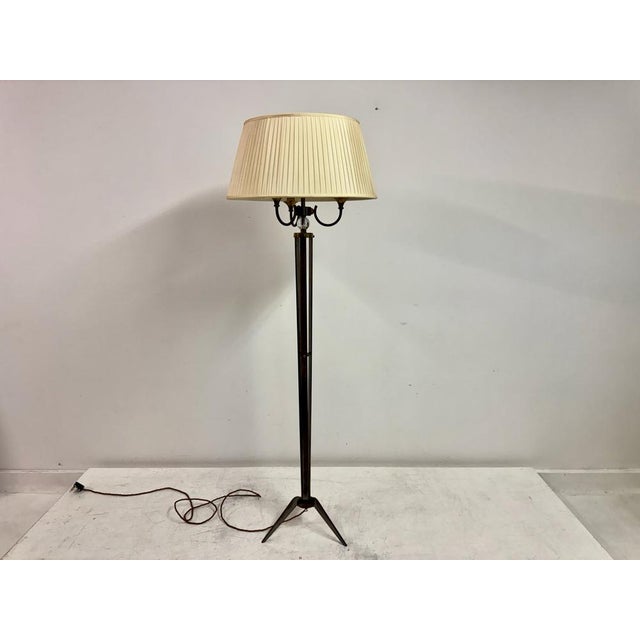 A refined french brass floor lamp attributed to maison jansen, dating from the mid-20th century. the lamp features a...