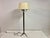 A refined french brass floor lamp attributed to maison jansen, dating from the mid-20th century. the lamp features a...