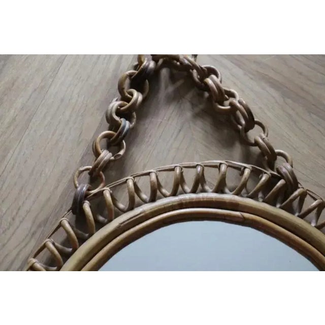 This very decorative vintage round mirror was made in Italy in 1960s. It is typical of this period design and is all...
