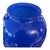 A striking cobalt blue glass vase with rounded shoulders, a gently tapered body, and a softly flared rim. Its vivid color...