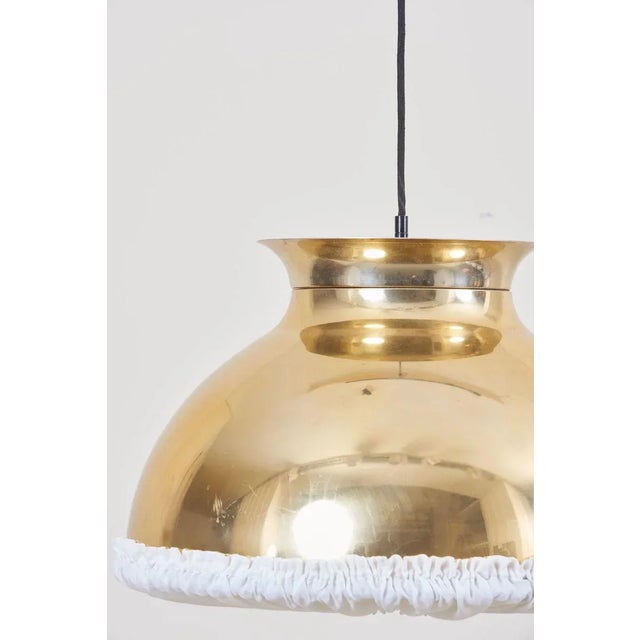 One of eight huge gold-colored pendant lamps with fabric. The lamps should be checked locally by a specialist concerning...