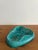 A signed and dated teal glazed pottery ashtray. Signed Catherine de Vol 1951. Some hairline cracks. Please see photos. 8”...