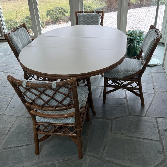 Amazing vintage rattan dining set (c. 1990s) attributed to Clark Casual Distinctive Rattan. The set includes (4) dining...