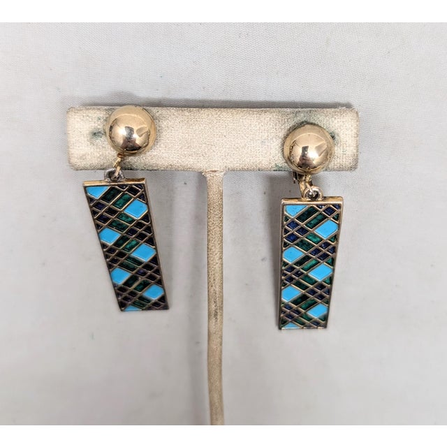 Circa late 1960s goldtone round domed top with rectangular drop with checked sections of navy blue, turquoise and green...