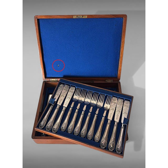 Elegant English silver-plated flatware service, comprising 12 fruit place settings (knives and forks) and 12 fish place...