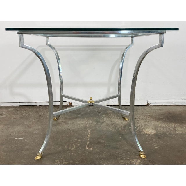 Vintage square Maison Jansen style brushed steel glass top table with brass hoofed feet. Elegant Neoclassical design...