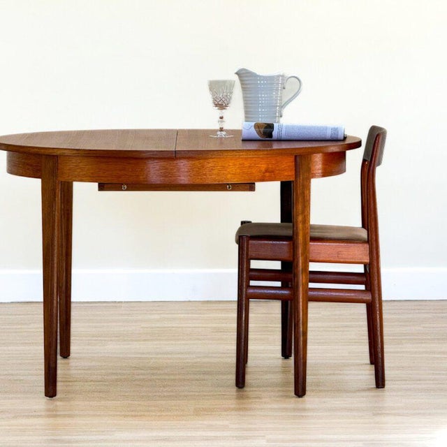 A beautiful Mid-Century round extending dining table designed by John Herbert and handcrafted by A. Younger in Britain...