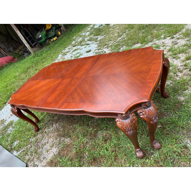 An exquisite vintage French Provincial Louis XV style extendable dining table crafted from high-quality solid cherry wood....