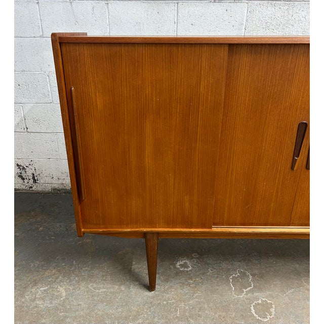 This wonderful Danish teak credenza or high sideboard is ready to be the star of your dining room. With a warm teak tone,...