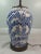 Beautiful, hand-painted flow blue ceramic lamp. Large, ginger style vase base with bronze embossed banding on base and...