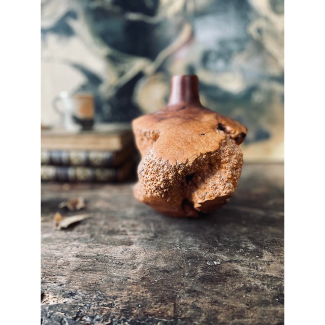 exquisite burl wood vase characterized by patterns and swirls that have resulted from abnormal growth of the tree, each...