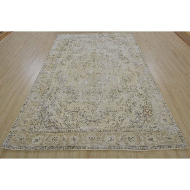 An authentic vintage traditional Tabriz rug hand-knotted with fine wool and natural dyes. This oriental rug features a...