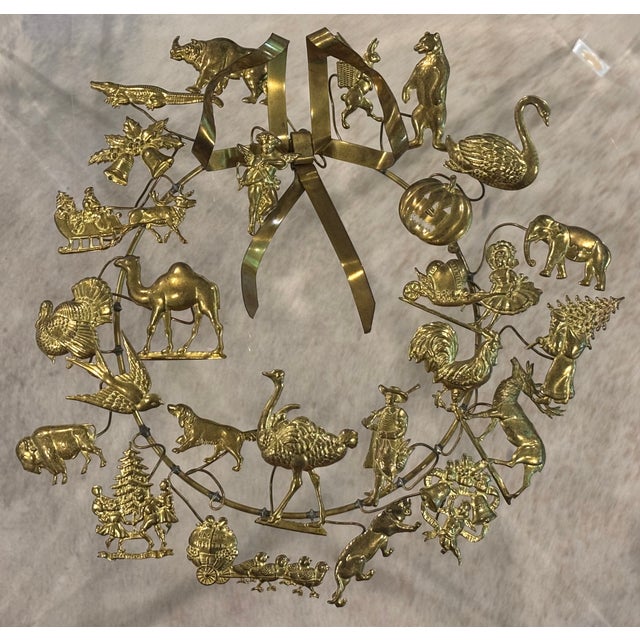 Charming and collectible brass "Dresden-style" holiday wreath with a mix of animals and holiday figures. CONDITION: Good...