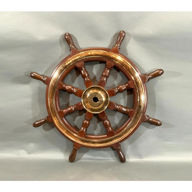 Eight spoke ships wheel with solid brass – Lannan Gallery with brass hub and trim ring. Eight turned posts are fitted to a...