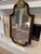 Large decorative wall mirror featuring a rich dark mahogany finish with antiqued gold accents and elegant carved details....