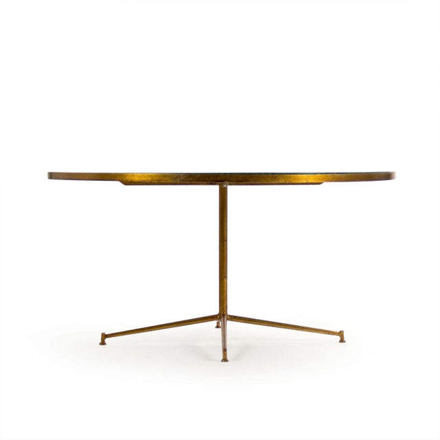 Round coffee table with deep green marble top and gold leaf finished base.