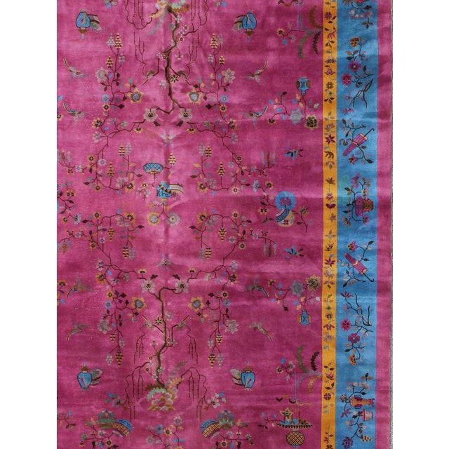 Measures: 10'10'' x 17'3''. This grandiose Chinese Art Deco rug features vibrant colors of blue, gold, green and magenta,...