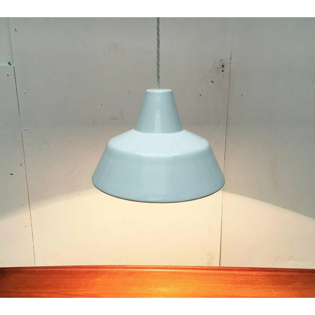 Simple enamel pendant lamp in orange from the Danish manufacturer Louis Poulsen. Also known as an enamel collector or...