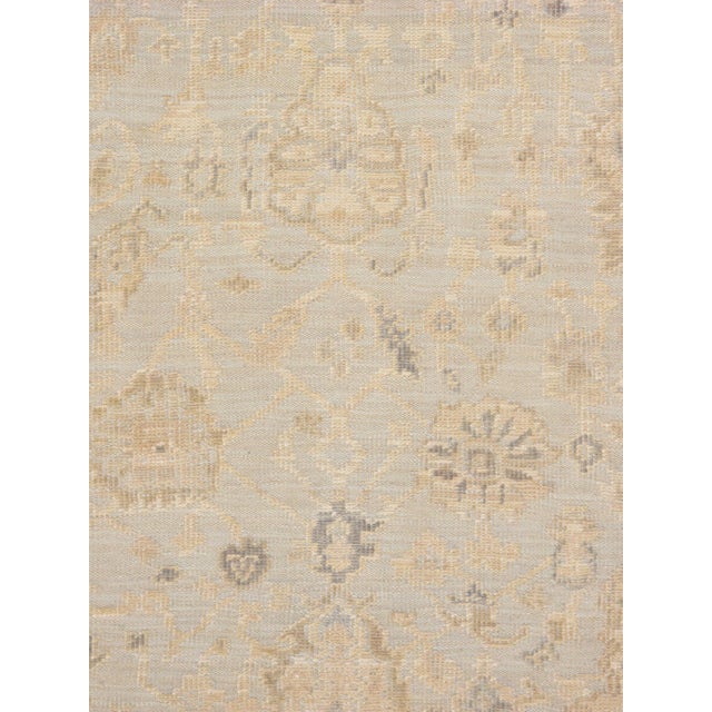 Expertly hand-knotted from fine wool, this Oushak rug showcases the collection's signature large-scale semi-geometric...