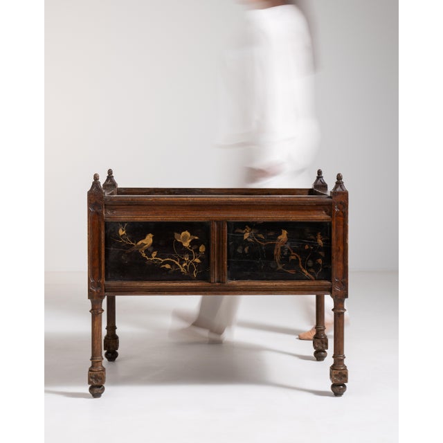 A decorative jardinière featuring detailed painted or carved floral and bird motifs characteristic of mid-19th century...