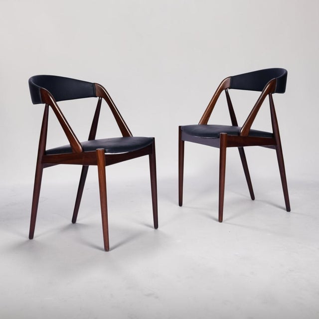Rare, set of 8, Kai Kristiansen for Schou Andersen Model #31 Danish rosewood dining chairs. The vintage 1960s Danish...