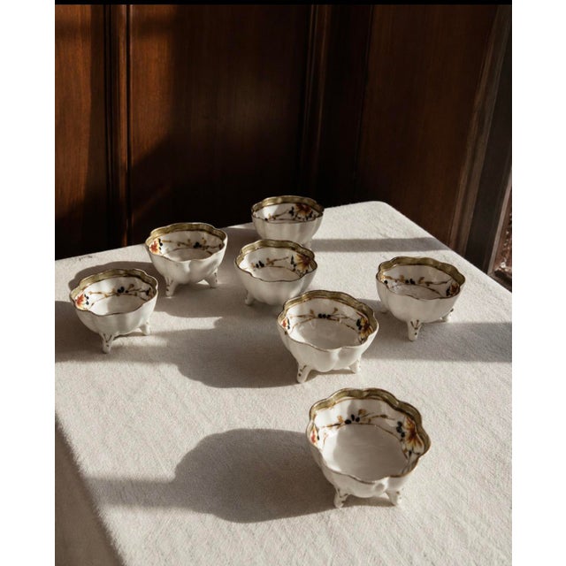A complete and charming set of eight antique Japanese open salt cellars, each marked “Hand Painted NIPPON” — placing their...