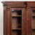 Small walnut display cabinet crafted in dark walnut. The bookcase features turned column details flanking three doors. The...