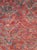 A vintage Moroccan rug in gallery format handmade during the late 20th century with tribal design elements over a deep red...