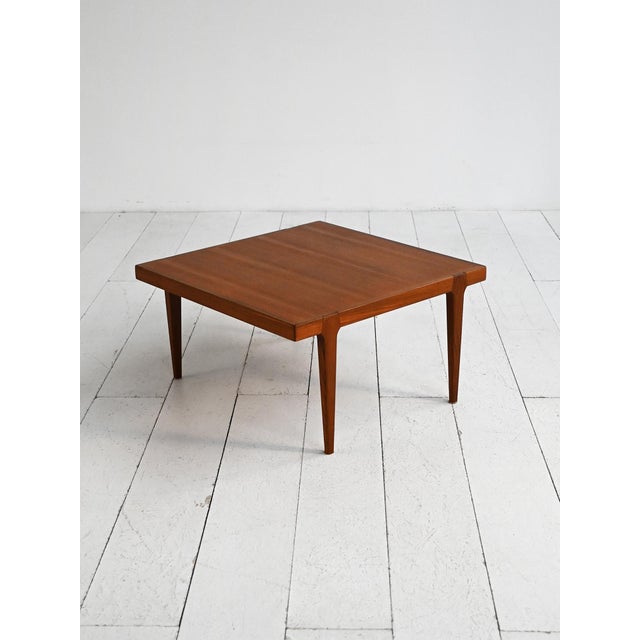 Square teak coffee table with tapered legs and exposed joints. Designed by Erik Wörtz, 1960s. Designed by Erik Wörtz in...