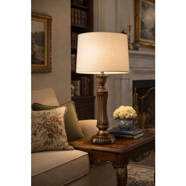 Classic vintage table lamp with a richly toned, fluted column body, original linen drum shade, and elegant turned...