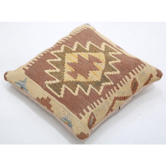 A one-of-a-kind handwoven Afghan wool kilim accent pillow featuring serrated star medallion. Cut and sewn by hand from a...