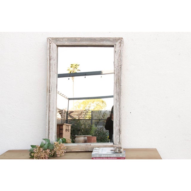 There is a quiet poetry in repurposing the past. This mirror was once a functional antique window frame, perhaps looking...