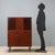 Vintage 1960s sideboard made of mahogany veneered wood, featuring hinged doors and central visible drawers. The structure...