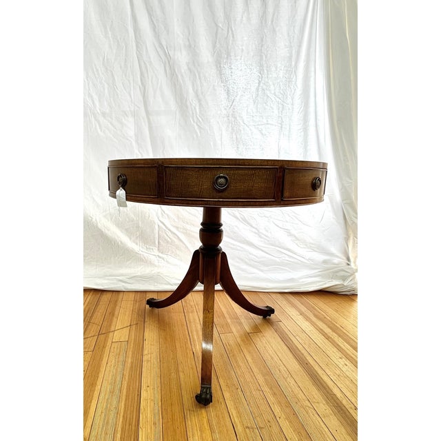 Elegant Kittinger drum table crafted in rich mahogany with beautifully grained wood top. Features one working drawer with...