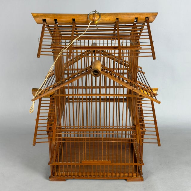 An exotic and meticulously crafted decorative aviary in the shape of a pagoda, attributed to 20th-century craftsmanship....