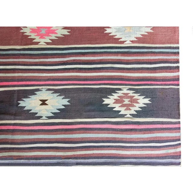 A wonderful vintage Turkish Bergama kilim rug with a striped pattern of alternating thin violet, cranberry, cream, and...