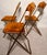 Vintage folding banquet chairs by Fritz & Co., featuring brass-tone metal frames and rust velvet upholstery. These chairs...