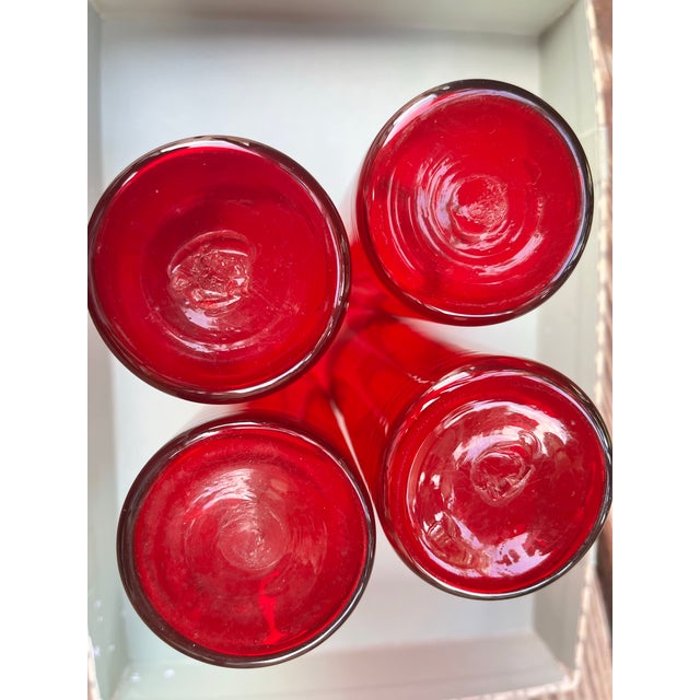 Beautiful set of 4 vintage hand-blown ruby red glass tumblers. Each piece features a pontil mark on the base, a hallmark...