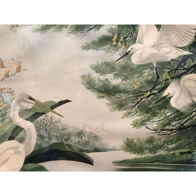 Original post-war Mid-Century tropical print featuring a group of cranes in a tropical lagoon. This artwork print comes in...