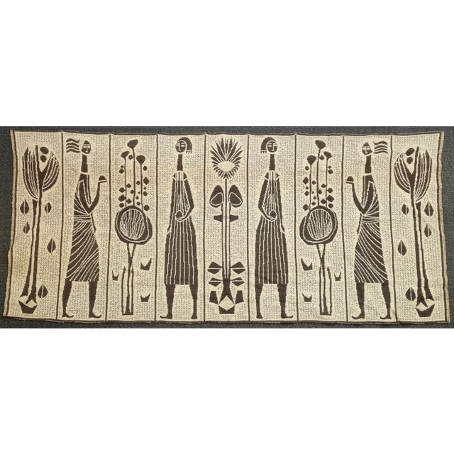 Wall hanging from the 1970s, created by László Pécsi. Decorative fabric with stylized human and plant motifs woven on both...