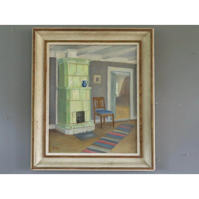 INTERIOR WITH GREEN STOVE Size: 23.2 x 20.1 inches (including frame) Oil on canvas A serene mid-century interior scene...