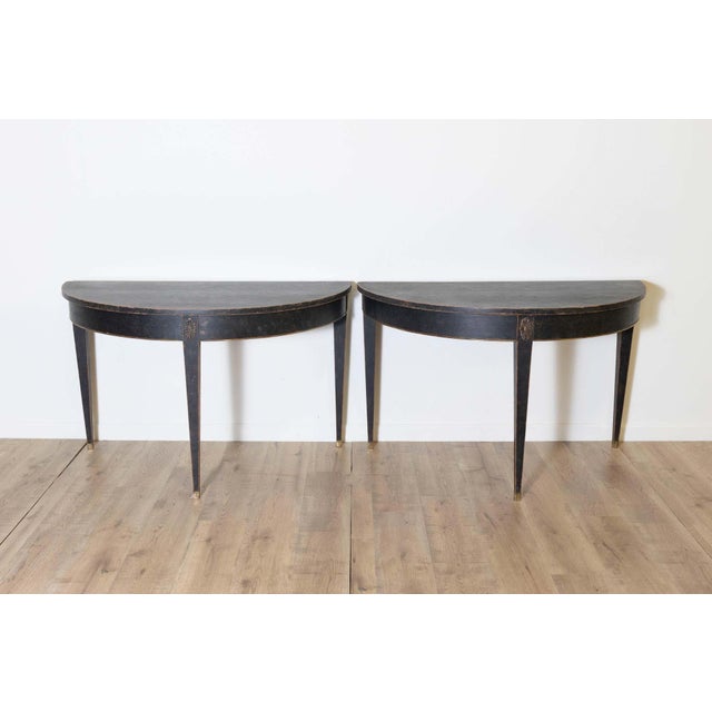 This pair of 19th-century Swedish demi-lunes, circa 1800, perfectly captures the elegance and simplicity of Neoclassical...
