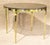 Round dining table with polished brass base. Wood veneer top complimented by long slender brass legs.