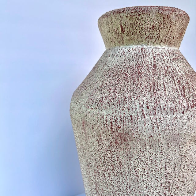 A beautiful textured ancient-style vase with soft pink and cream undertones that adds warmth to any space. Pair with other...