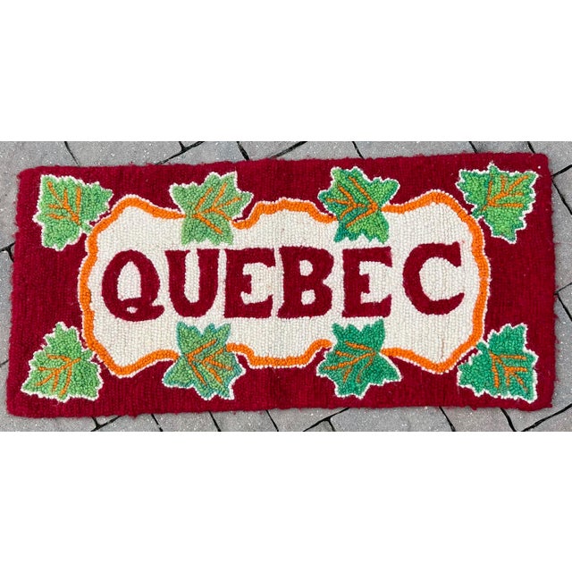 Announce to the world your love for Quebec with this eye-catching vintage hooked wool wall hanging. The deep red...