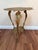 Vintage Art Nouveau style pedestal side table in gold-toned cast metal, featuring a pierced top with flowing florals and a...