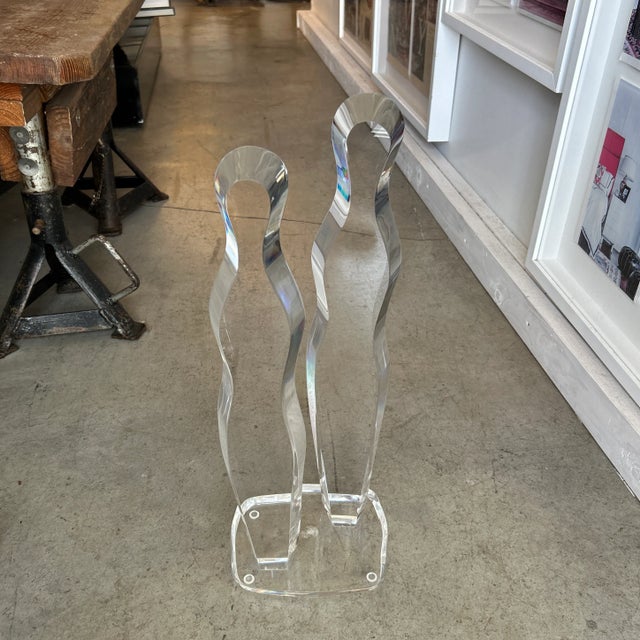 Abstract beveled lucite sculpture depicting 2 people. Excellent condition with one dry interior spot on there base. Made...