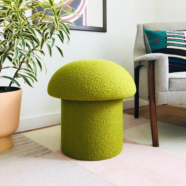 A handmade mushroom shaped stool, upholstered in "Pistachio" curly boucle fabric. Pistachio is a yellow-green color....
