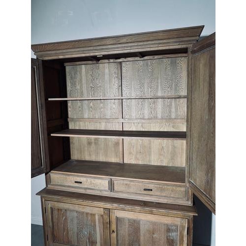 Spacious and characterful two-part oak cabinet with a warm natural finish and clean architectural lines. This piece...
